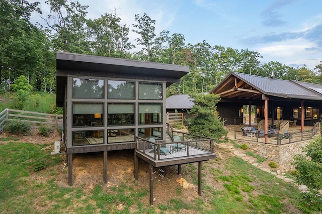 rear view of property featuring metal roof