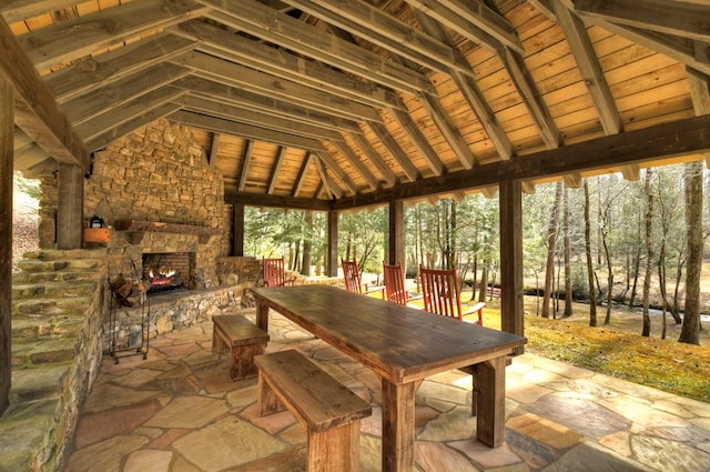 view of patio / terrace featuring an outdoor stone fireplace