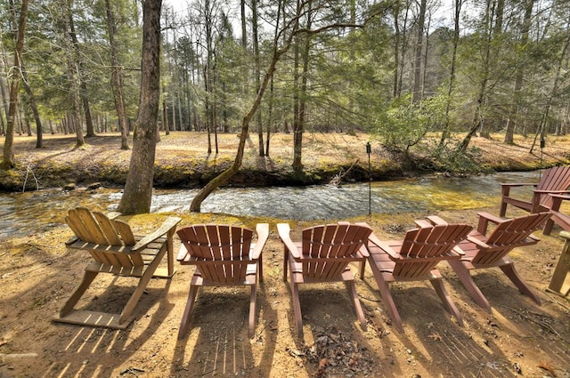 view of yard with a view of trees and a fire pit