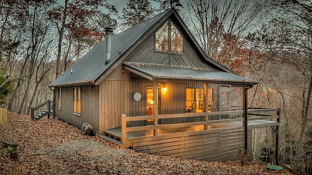 back of property featuring metal roof