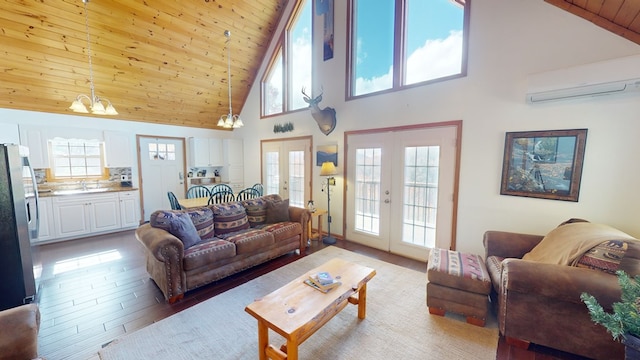 living room featuring wood ceiling, an inviting chandelier, hardwood / wood-style floors, a wall mounted AC, and french doors