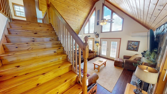 staircase featuring hardwood / wood-style flooring, an AC wall unit, wood ceiling, and french doors