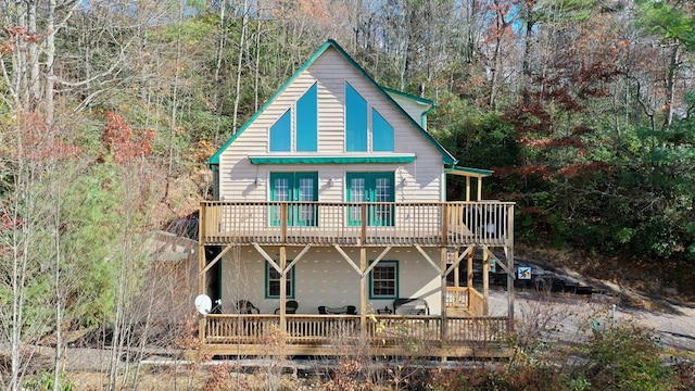 back of house featuring french doors and a wooden deck