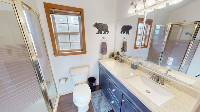 bathroom featuring vanity, hardwood / wood-style floors, an enclosed shower, and toilet