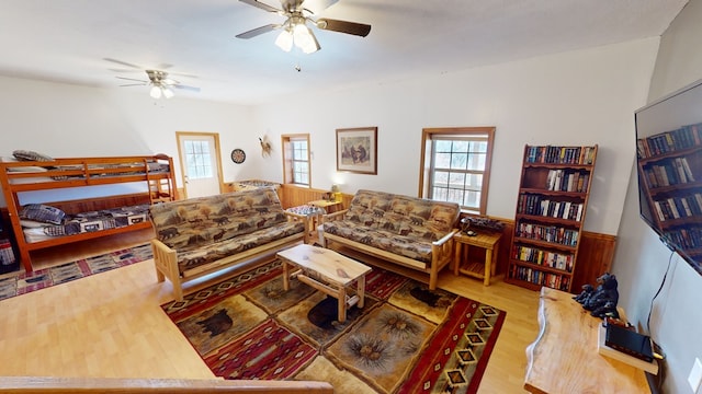 living room featuring ceiling fan and light wood-type flooring