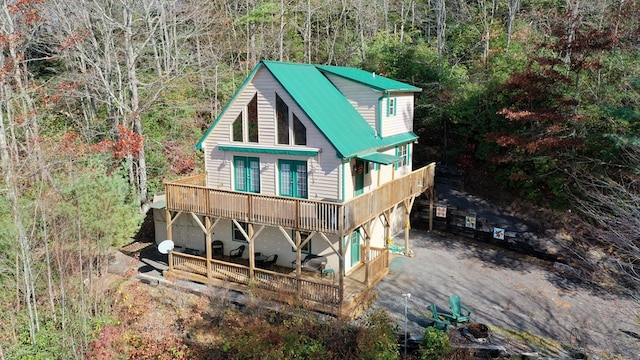 back of property with a wooden deck