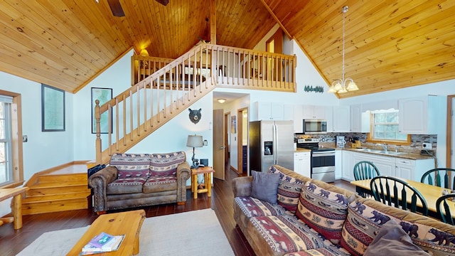 living room with dark hardwood / wood-style flooring, wooden ceiling, and an inviting chandelier