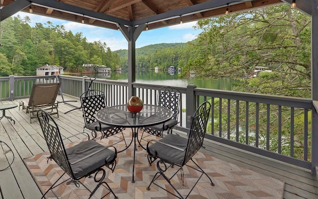 wooden terrace with a gazebo and a water view