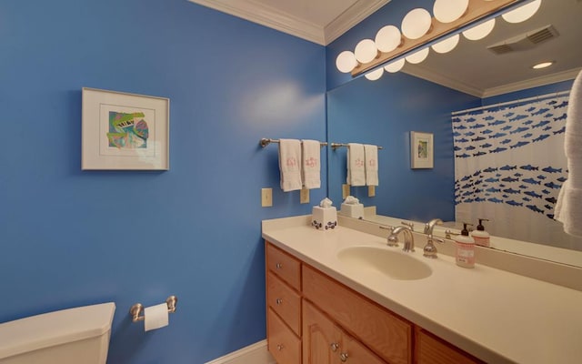 bathroom with crown molding, vanity, and toilet