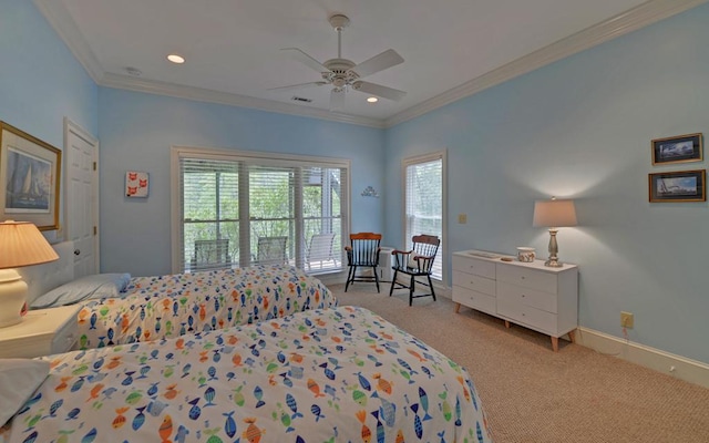 carpeted bedroom with ornamental molding and ceiling fan