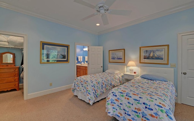 carpeted bedroom featuring crown molding, ensuite bath, and ceiling fan