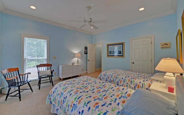 carpeted bedroom with ornamental molding and ceiling fan