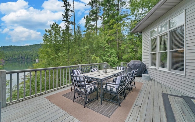 wooden terrace featuring a water view and area for grilling