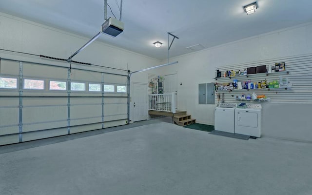 garage with a garage door opener and separate washer and dryer