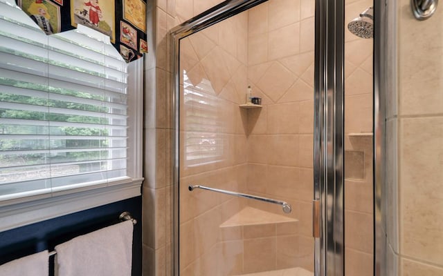 bathroom with a shower with shower door