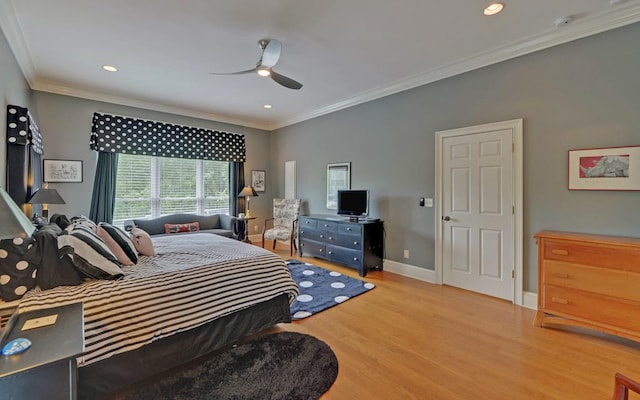 bedroom featuring ceiling fan, ornamental molding, and light hardwood / wood-style flooring