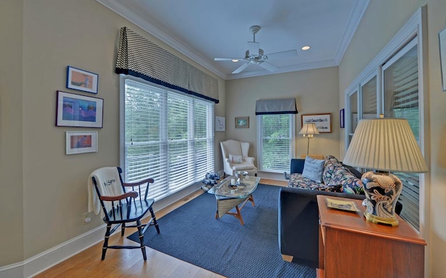 interior space featuring hardwood / wood-style flooring, ornamental molding, and ceiling fan