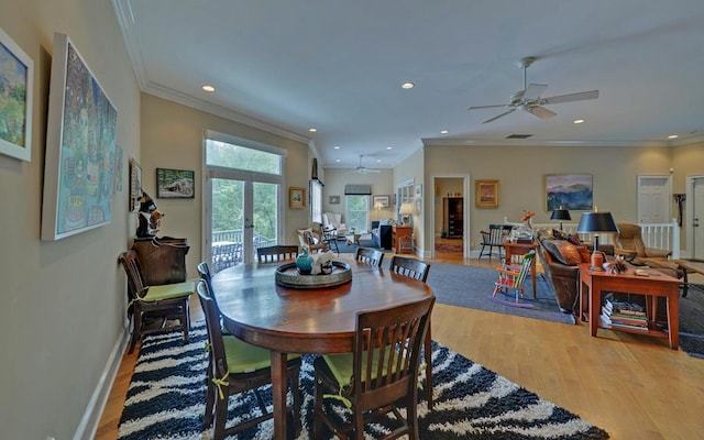 dining space featuring hardwood / wood-style flooring, ornamental molding, french doors, and ceiling fan