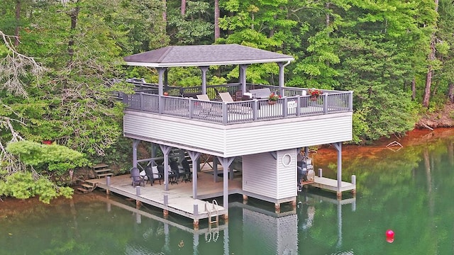 view of dock with a gazebo and a deck with water view