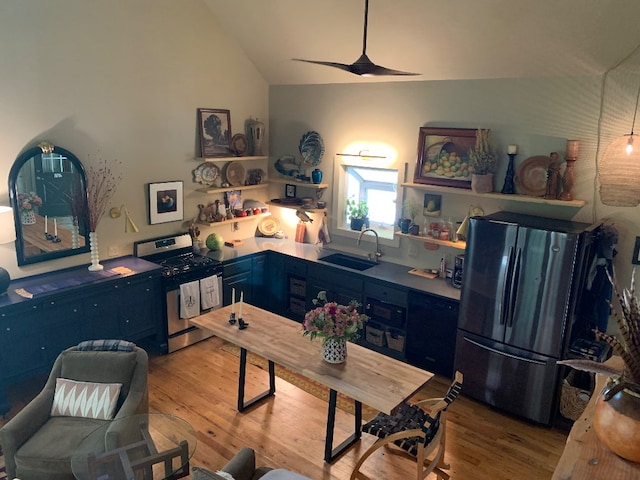 kitchen featuring sink, range, stainless steel fridge, blue cabinetry, and light hardwood / wood-style flooring