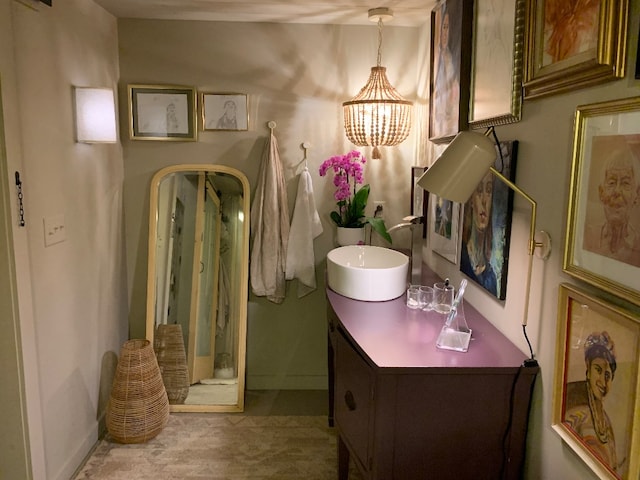 bathroom featuring vanity and a notable chandelier