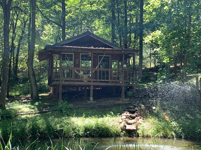 exterior space featuring a deck with water view