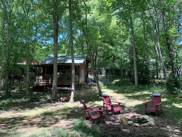 view of yard with an outdoor fire pit and a deck