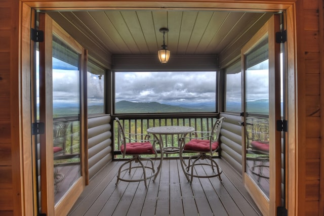 sunroom / solarium featuring plenty of natural light and a mountain view