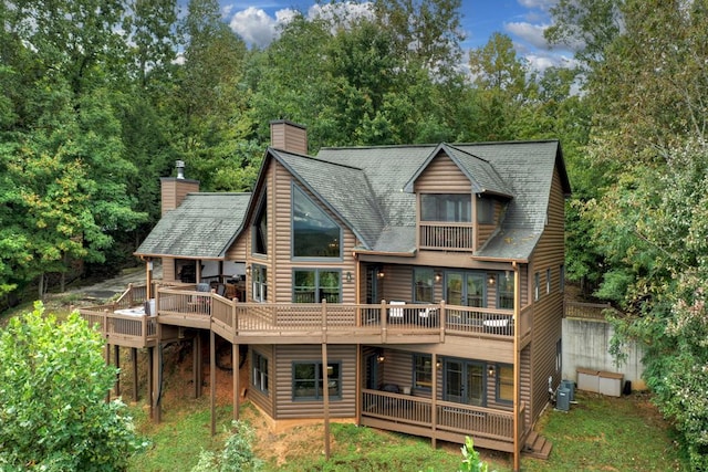 back of house featuring a balcony and a deck