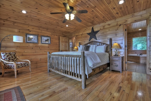 bedroom featuring ensuite bath, recessed lighting, light wood-style flooring, and wooden ceiling