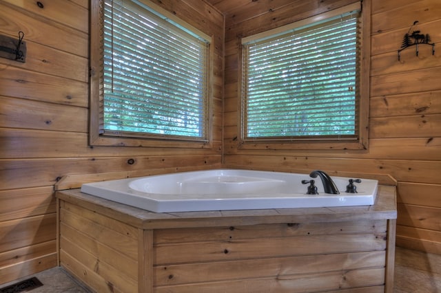 full bath with visible vents, a garden tub, and wooden walls