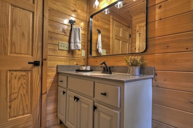 bathroom with wood walls and vanity