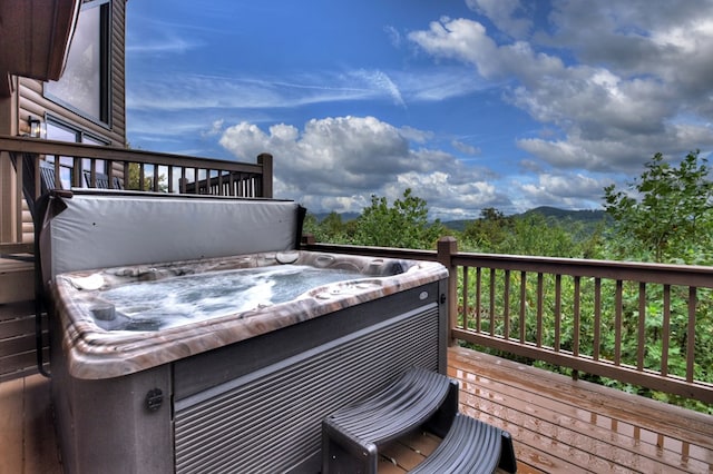 wooden terrace featuring a hot tub