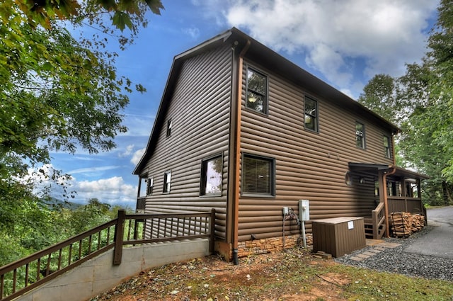 view of home's exterior with faux log siding