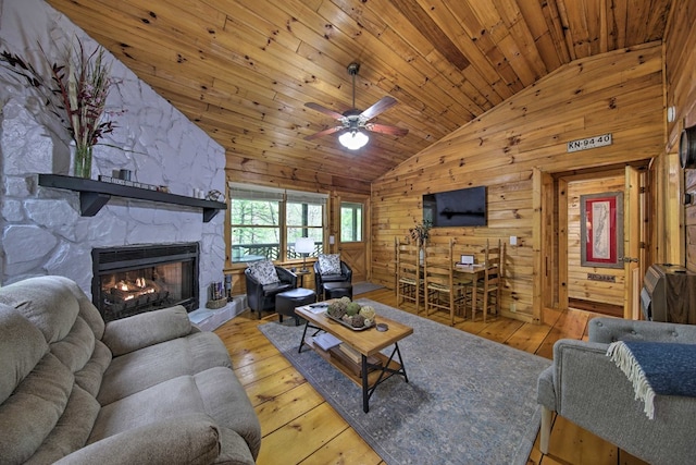 488 Joanne Sisson Rd, Blue Ridge, GA 30513 - living area with hardwood / wood-style flooring, wooden walls, a stone fireplace, wooden ceiling, and lofted ceiling