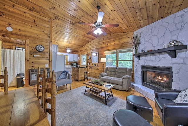 488 Joanne Sisson Rd, Blue Ridge, GA 30513 - living area featuring wood walls, wood ceiling, lofted ceiling, light wood-style flooring, and a fireplace