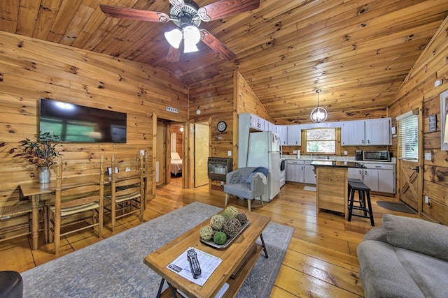 488 Joanne Sisson Rd, Blue Ridge, GA 30513 - living area with ceiling fan, light wood-style floors, wood walls, and vaulted ceiling