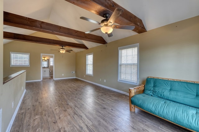 unfurnished room with vaulted ceiling with beams, ceiling fan, baseboards, and wood finished floors