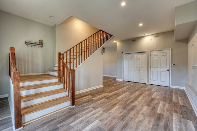 interior space with recessed lighting, wood finished floors, visible vents, and baseboards