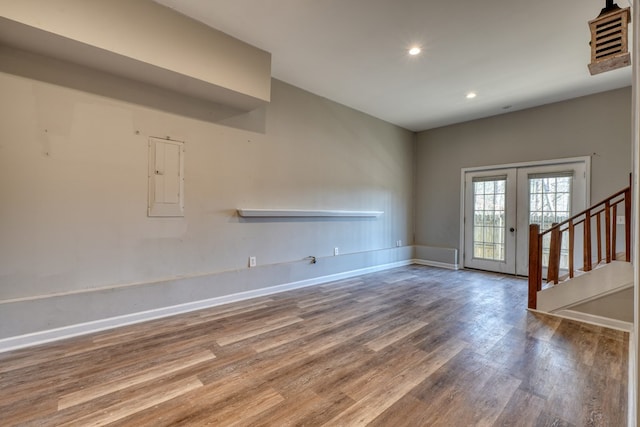 interior space featuring recessed lighting, wood finished floors, baseboards, french doors, and stairway