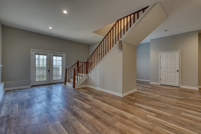 entrance foyer with recessed lighting, wood finished floors, baseboards, stairs, and french doors