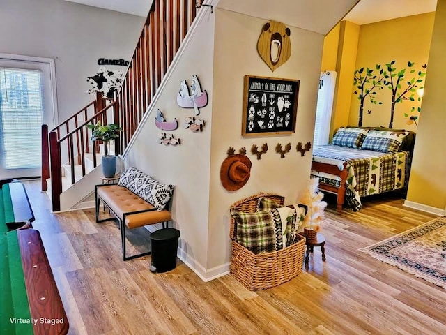 interior space with wood finished floors and baseboards