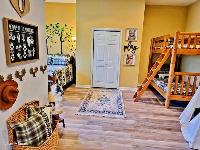 bedroom with baseboards and wood finished floors