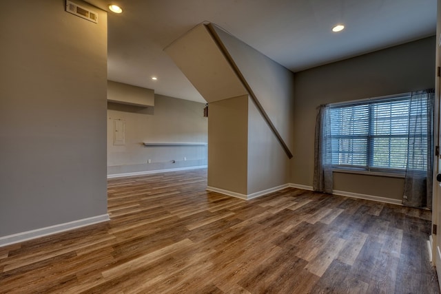 interior space featuring baseboards, visible vents, wood finished floors, and recessed lighting