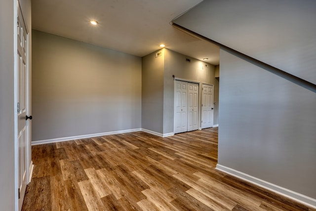 unfurnished room featuring baseboards and wood finished floors