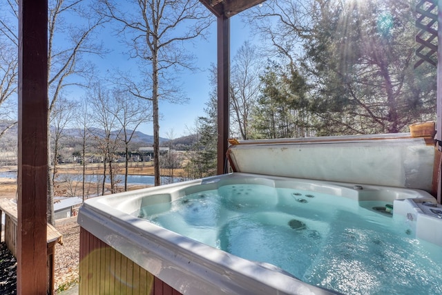 exterior space with a jacuzzi and a mountain view