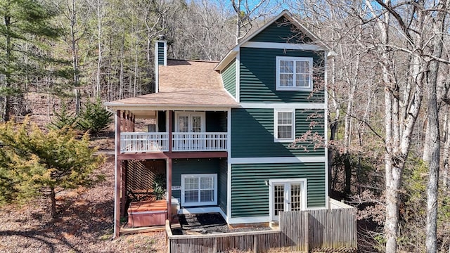 rear view of house with french doors and a balcony