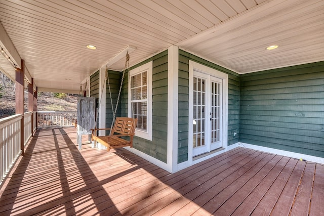 wooden terrace featuring a porch and french doors