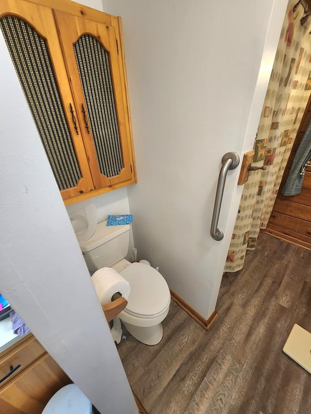 bathroom featuring wood-type flooring and toilet