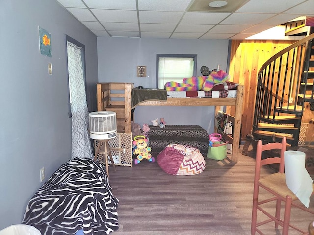 bedroom featuring hardwood / wood-style flooring and a paneled ceiling